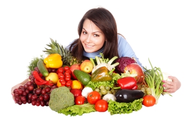 Girl with group of fruit and vegetables.